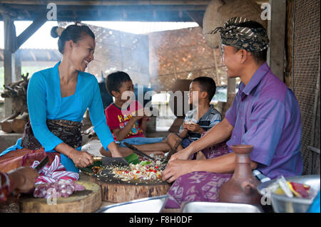 Asian family cooking together in outdoor kitchen Stock Photo