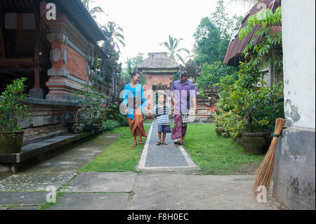 Asian mother, father and son walking outside ornate building Stock Photo