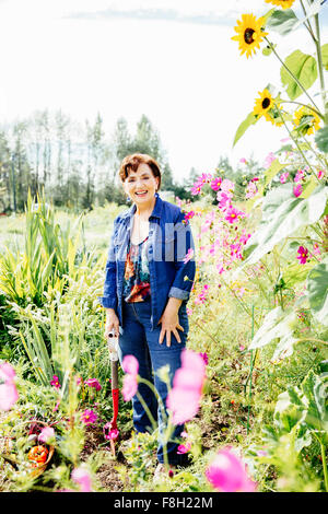Caucasian woman smiling in garden Stock Photo