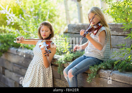 Musicians playing violins outdoors Stock Photo