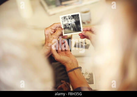 Women looking at family photographs Stock Photo
