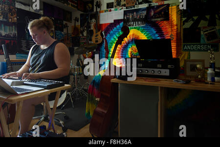 Caucasian man playing keyboard in music studio Stock Photo
