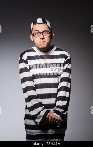 Funny prisoner isolated on gray Stock Photo