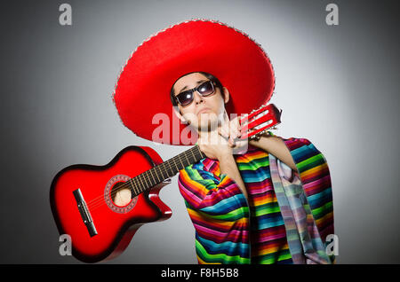 Man in red sombrero playing guitar Stock Photo