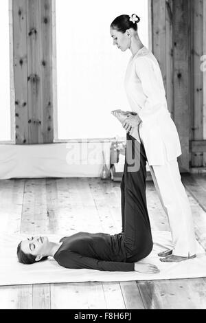 Woman getting thai stretching massage Stock Photo - Alamy