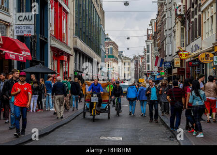 Tricycle taxi in busy street in city of Amsterdam Holland Stock Photo