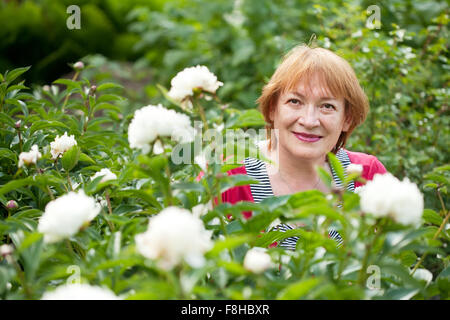 mature woman in pion plant at garden Stock Photo