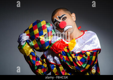 Sad clown against dark background Stock Photo