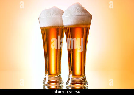 Beer glasses against the colorful gradient background Stock Photo