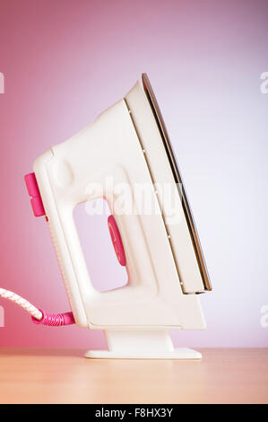 Modern electric iron against the colorful background Stock Photo