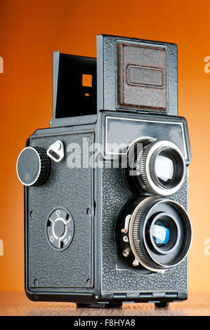 Vintage film camera against gradient background Stock Photo