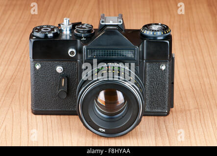 Vintage film camera against gradient background Stock Photo