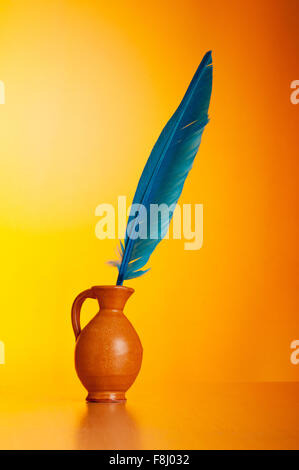 Writing feather against gradient background Stock Photo