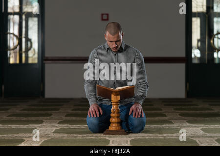 Muslim Man Is Reading The Koran Stock Photo