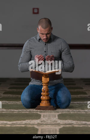 Muslim Man Is Reading The Koran Stock Photo