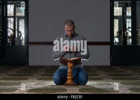 Muslim Man Is Reading The Koran Stock Photo