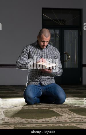 Muslim Man Is Reading The Koran Stock Photo