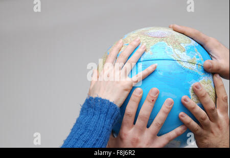 Teamwok concept with hands on globe(NIKON D80; 20.3.2007; 1/250 at f/5; ISO 400; white balance: Aut Stock Photo