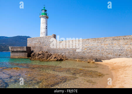 White stone lighthouse tower on the pier. Entrance to Propriano, Corsica island, France Stock Photo