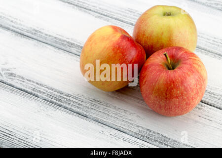 red apples on the white wooden background. Stock Photo