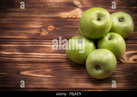 green apples on the brown wooden background. Stock Photo