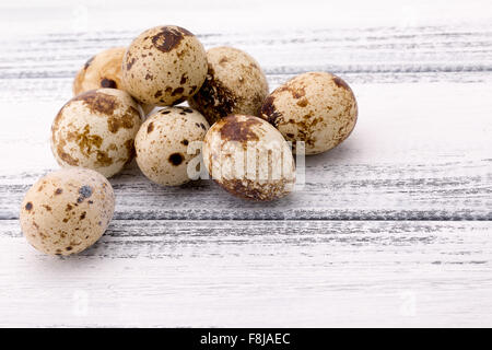 quail eggs on a white wooden background. Stock Photo