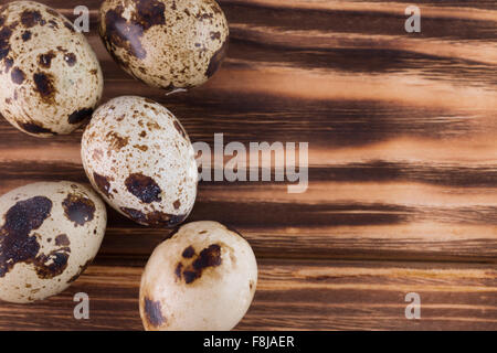 quail eggs on a brown wooden background. Stock Photo