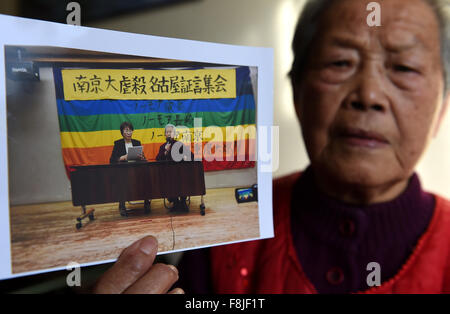 (151210) -- NANJING, Dec. 10, 2015 (Xinhua) -- Ai Yiying, 87, survivor of the atrocious Nanjing Massacre, shows her photo at home in Nanjing, capital of east China's Jiangsu Province, on Dec. 3, 2015. Ai Yiying survived in the Nanjing Massacre when she was 9 years old. She witnessed in a hideout that her father Ai Renyin, her uncles Ai Renbing and Ai Renlin, her cousin Ai Yisheng were forced away and killed by Japanese army. Some survivors of the Nanjing Massacre held family memorial rites for their lost relatives at the Memorial Hall of the Victims in the Nanjing Massacre by Japanese Inva Stock Photo