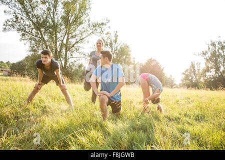 Group of friends exercising in field