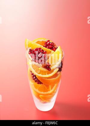 Ingredients in drinking glass for orange and pomegranate fruit juice Stock Photo