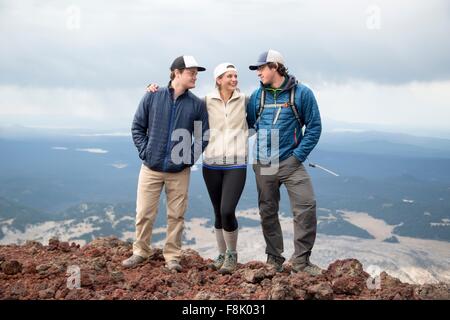 Three friends standing at the summit of South Sister volcano, Bend, Oregon, USA Stock Photo