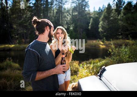 Young couple eating grapes on riverside, Lake Tahoe, Nevada, USA Stock Photo