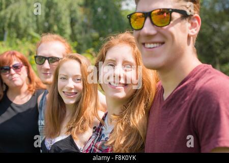 Red haired family group in a row looking at camera smiling Stock Photo