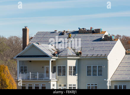 Workers on town house roof removing old slates / no safety equipment or  helmets - France Stock Photo - Alamy