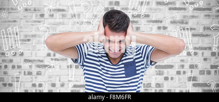 Composite image of frustrated man covering ears Stock Photo