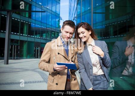 Businessman and woman using digital tablet Stock Photo