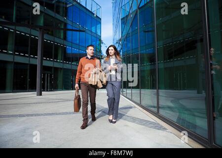 Casual businessman and woman on way to work Stock Photo