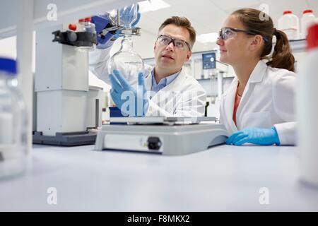 Scientists using rotary evaporator in laboratory Stock Photo
