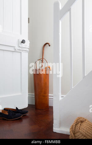 Grade II Listed Country Lodge in Weybridge. White-painted hallway with an umbrella stand. Contemporary interior. Stock Photo