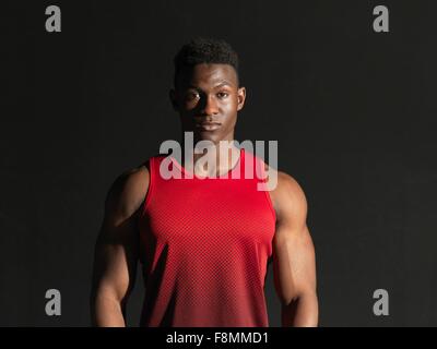 Portrait of athlete, black background