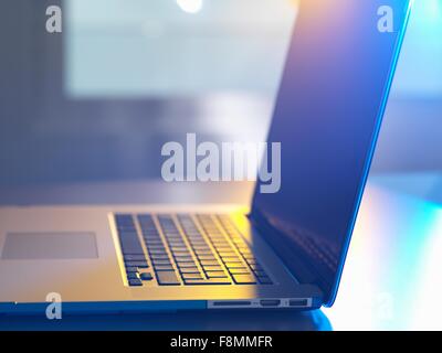 Side view of open laptop on desk Stock Photo