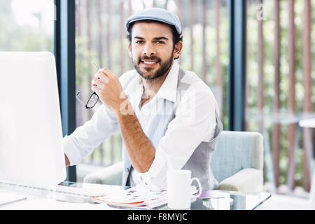 Smiling man working on computer Stock Photo