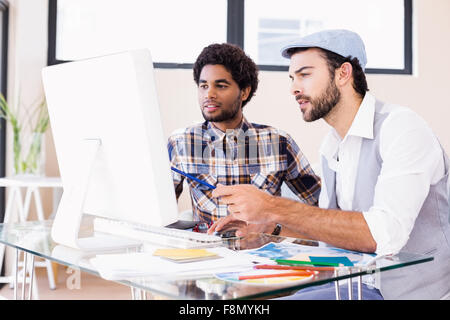 Focused gay couple working on computer Stock Photo