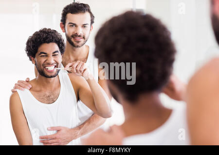 Reflection of happy gay couple in bathroom Stock Photo