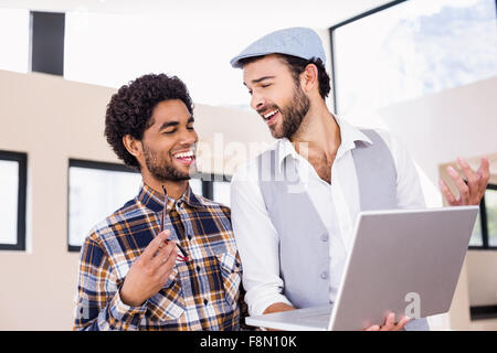 Happy gay couple using laptop Stock Photo