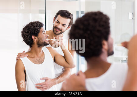 Reflection of happy gay couple in bathroom Stock Photo
