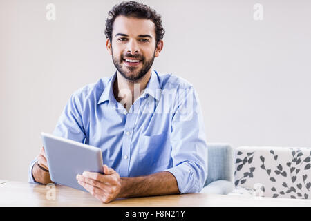 Handsome man using tablet Stock Photo
