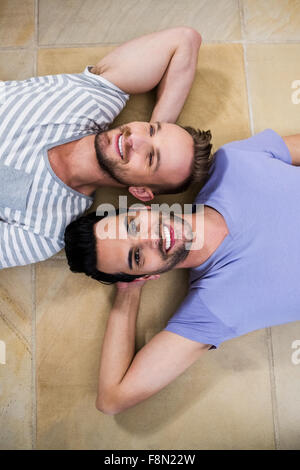 Gay couple lying on floor Stock Photo