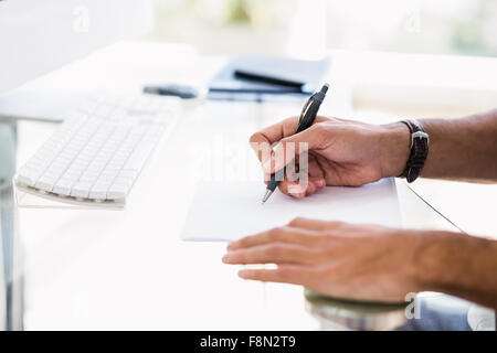 Close up of man taking notes Stock Photo