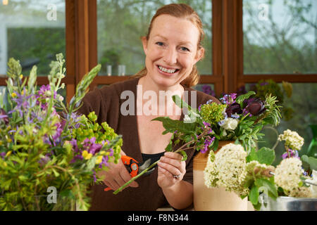 Florist Working On Arrangement In Flower Shop Stock Photo